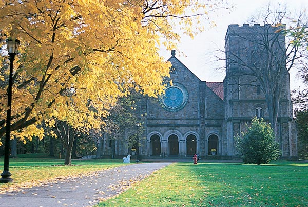 Exterior view of the Vassar College Chapel. The Tiffany Rose Window can be seen above the arched entrance.