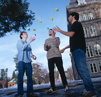 Three students juggling