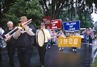 a band plays as the various reunion classes parade towards Walker