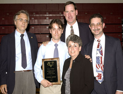 Steve Money '03 stands with his parents and coaches as he accepts the award for Outstanding Senior Male Athlete
