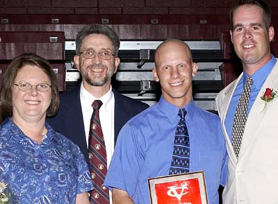 From left to right: Mr. and Mrs. Reinhardt with their son, Tim '04, and baseball coach Chris Campassi