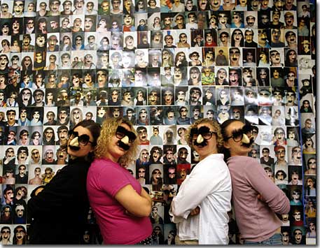 Students in front of groucho wall of photos