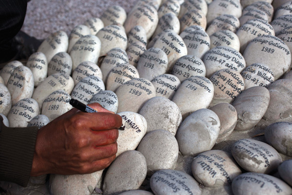 As a way to remember those who disappeared during the nation’s 20-year civil conflict, family members write the victims’ names on rocks. 
