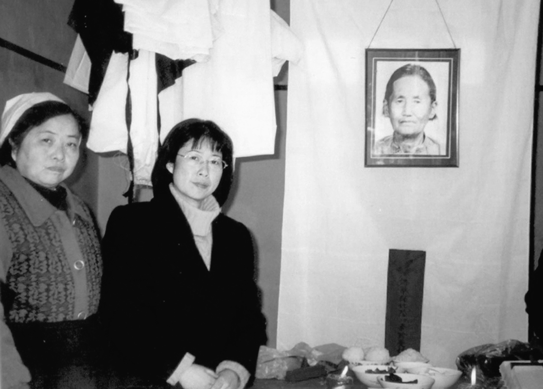 Chen Lifei, on right, attends the funeral of Ly Xiuzhen, one of several survivors who died before the book was published.